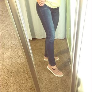 Dark blue lightly distressed skinny jeans